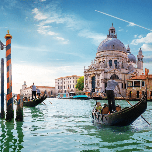Canal Grande mit darauf fahrenden Teouristen-Gondeln im Hintergrund die prunkvolle Salutekirche.